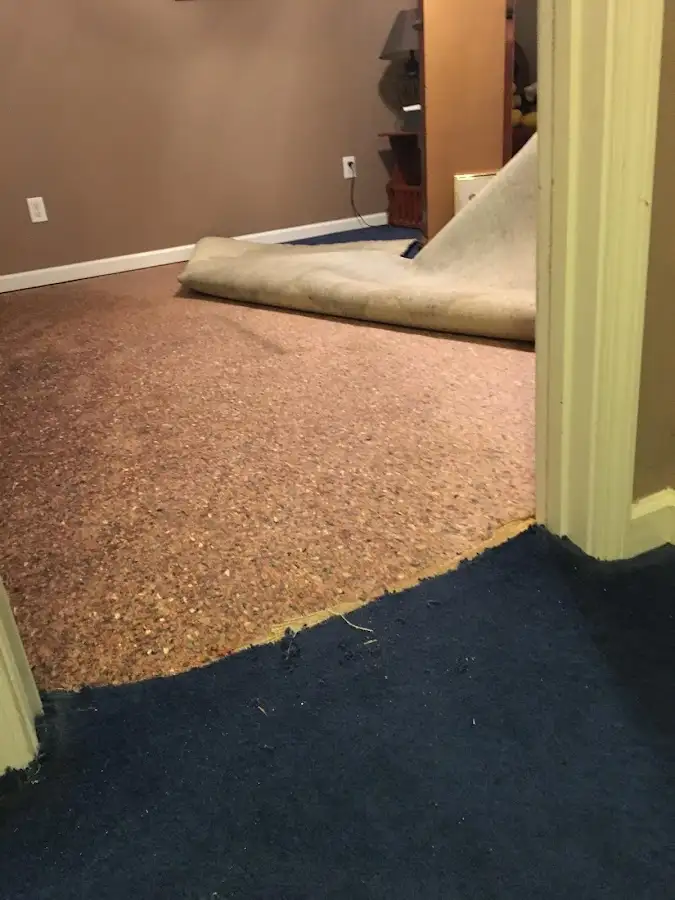 Carpet pad removal revealing water damage during Water Mitigation Services in Opelousas